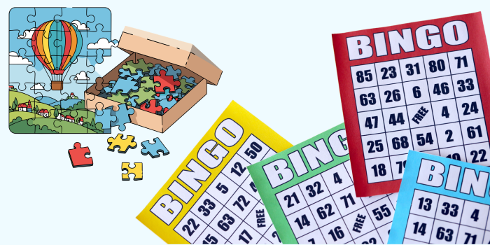 Partially completed puzzle with extra puzzle pieces in a box and an array of Bingo cards.