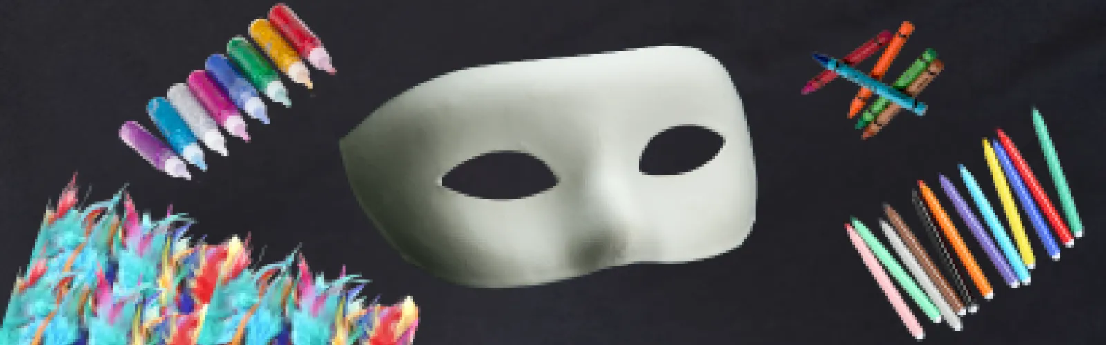 Art supplies surounding a blank Halloween mask, ready for decorating.